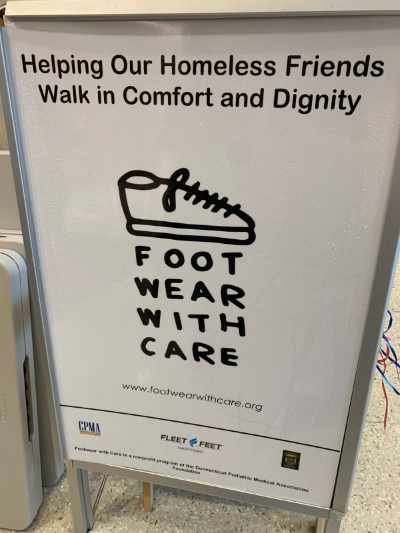 Floor sign with the Footwear with Care logo.